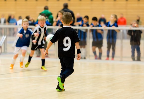 Gutter som spille fotball inne. 